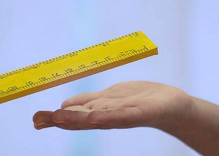 ruler and hand on a blue background